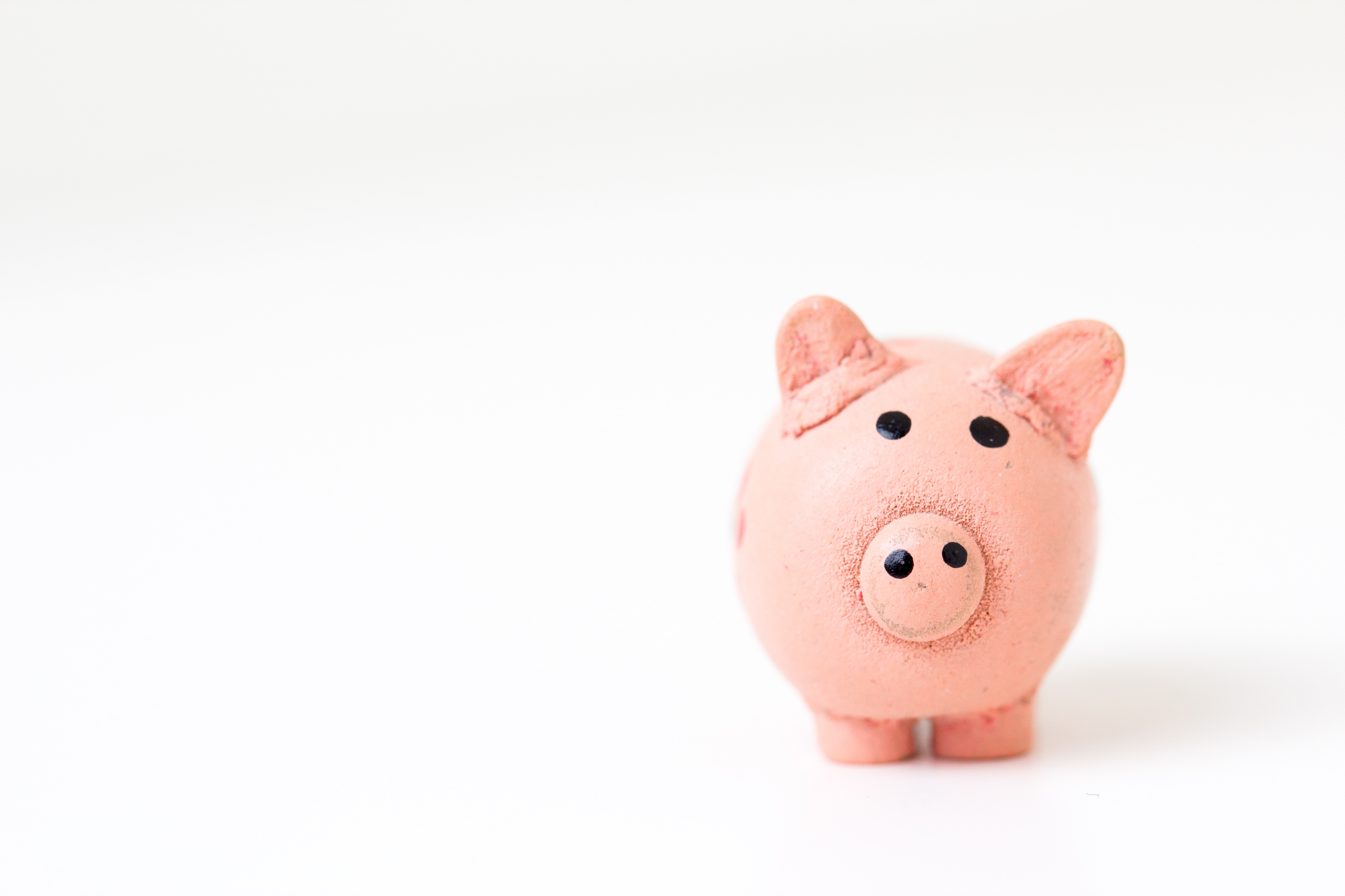 This image of is of a piggy bank and the post is about how decentralized finance offers solutions to some of the issue facing traditional finance.